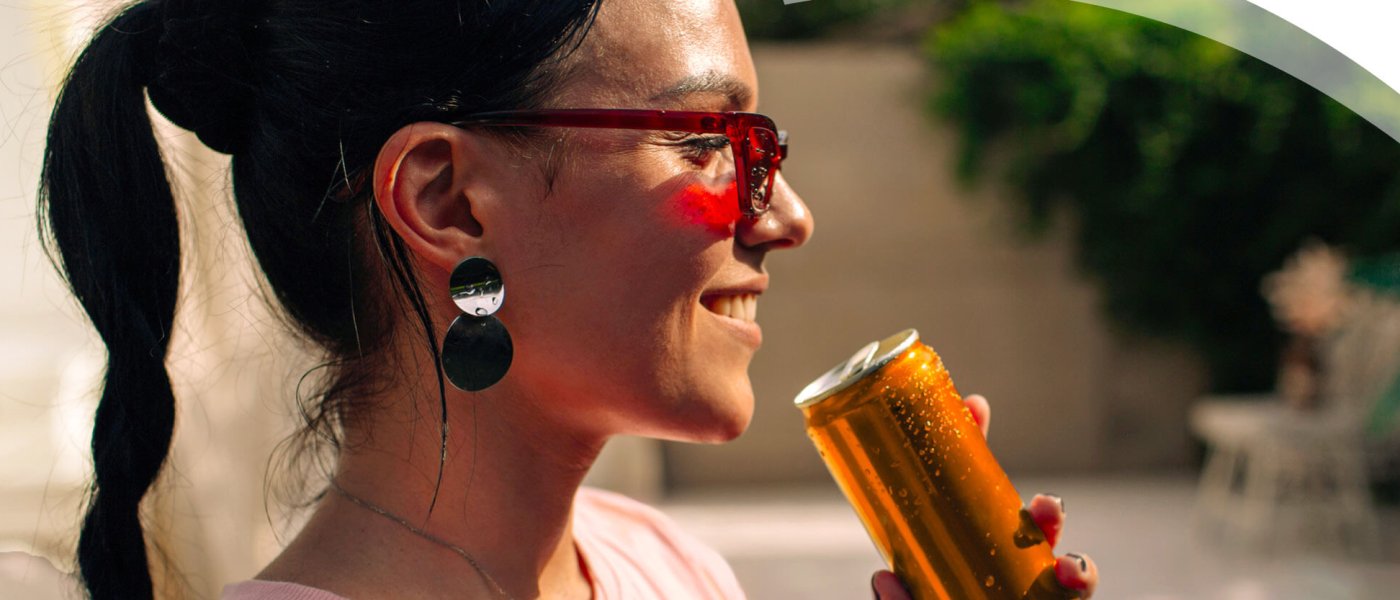 Young woman drinking out of a can
