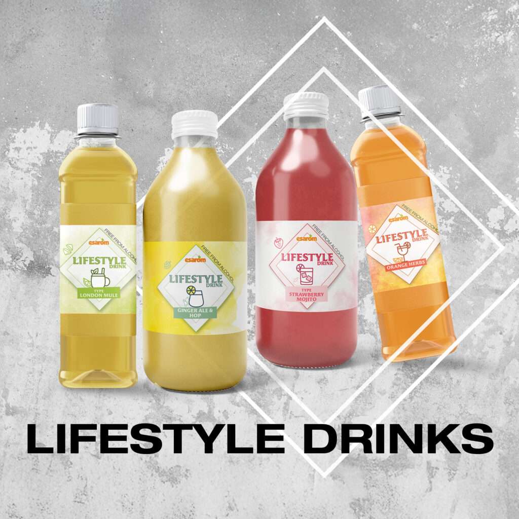 Four bottles of colorful lifestyle drinks are displayed in front of a textured gray background with white geometric lines. Each prosweets bottle features a distinct label and flavor, including ginger, lemon mint, strawberry, and vitamin boost.
