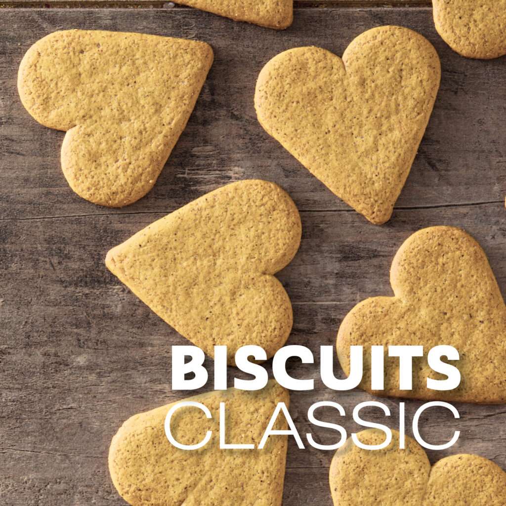 Heart shaped biscuits on a rustic wooden surface with the text “BISCUITS CLASSIC” overlaid in bold white letters.