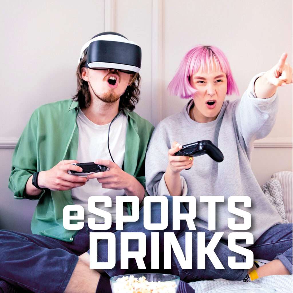 Two excited young adults sit on a couch playing video games; one wears a VR headset, both hold controllers. Popcorn is on the table in front. The text "eSPORTS DRINKS" is overlaid on the image.