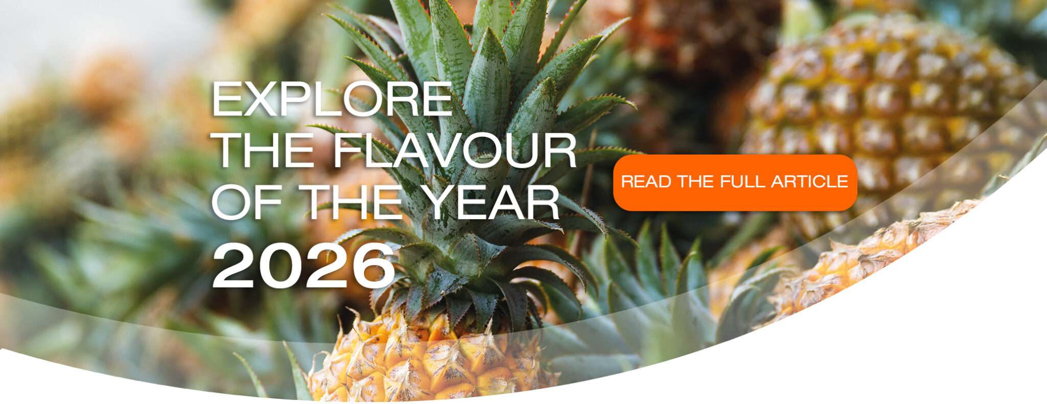 Close up of ripe pineapples with text overlay: "Explore the flavours of the year 2026" and an orange button that says "Read the full article.