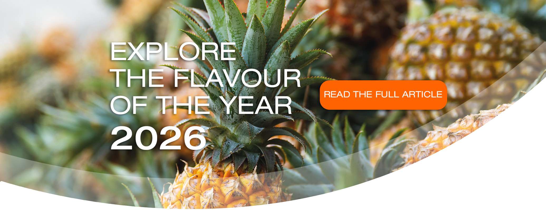 Close-up of several pineapples with text overlay: "Explore the вкус of the year 2026." An orange button says, "Read the full article.