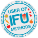 A circular badge with the words “User of IFU Methods,” decorated with fruit illustrations—apple, orange, passionfruit—and a drink splashing, repeated text around the border, celebrating a multi sensory approach to transforming discovery.